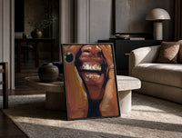 Framed Grillz Smile print on the floor, leaning against a travertine table