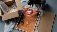 Smile with a Butterfly Pendant framed print being unpacked from protective bubble wrap and a box