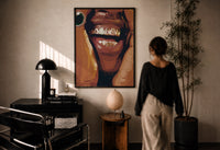 Smile with Multicolored Grillz print in a black frame on a sunlit plaster wall, a woman looking on beside a mushroom lamp