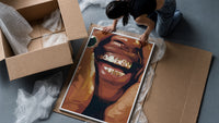 Smile with Multicolored Grillz framed print being unpacked from protective bubble wrap and a box