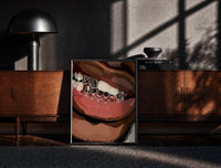 Black-framed Smile with Silver Grillz print on the floor in front of a dark wooden console