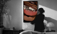 Smile with Silver Grillz print in a slim black frame being hung on a sunlit wall in a monochrome room