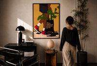 Sneakers and a Plant-Filled Tote print in a black frame on a sunlit plaster wall, a woman looking on beside a mushroom lamp