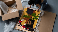Sneakers and a Plant-Filled Tote framed print being unpacked from protective bubble wrap and a box