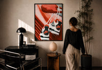 Sneakers Hanging from a Car Mirror print in a black frame on a sunlit plaster wall, a woman looking on beside a mushroom lamp