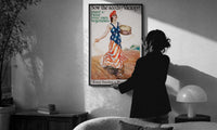 Sow the Seeds of Victory print in a slim black frame being hung on a sunlit wall in a monochrome room