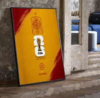 FIFA World Cup 2026 Spain emblem print in a black frame leaning beside a vintage door on parquet