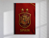 Spain national football crest emblem poster in a slim frame on a bright wall with soft window light
