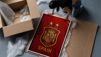 Spain national football crest emblem framed print being unpacked from protective bubble wrap and a box