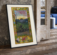 Sunrise over face in landscape print in a black frame leaning beside a vintage door on parquet