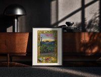 Black-framed Sunrise over face in landscape print on a moody console with designer coffee-table books