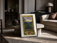 Sunrise over face in landscape print in a black frame leaning on a travertine table in a sunlit lounge