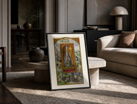 Alchemical crowned flask with child dragon print in a black frame leaning on a travertine table in a sunlit lounge