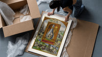 Alchemical crowned flask with child dragon framed print being unpacked from protective bubble wrap and a box