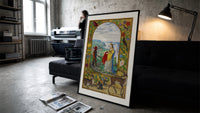 Crowned angelic woman and red-skinned man print in a slim black frame leaning on a dark sofa in a concrete print studio