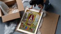Three-headed dragon in alchemical flask framed print being unpacked from protective bubble wrap and a box
