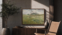 Poppy wildflower meadow landscape print in a wood frame above a fluted sideboard beside an olive tree