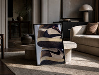 Stacked Brown and Cream Sneakers print on the floor, leaning against a travertine table