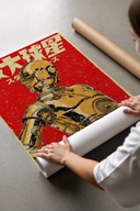 Woman unrolling Star Wars C-3PO Japanese Retro poster on concrete floor with cardboard tubes beside her