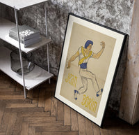 Dancer in blue cap leaping poster in a black frame leaning beside a shelf in a raw-plaster loft