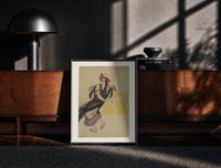 Black-framed Flamenco dancer with flowers in hair print on a moody console with designer coffee-table books