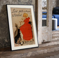 Girl in red dress drinking from bowl print in a black frame leaning beside a vintage door on parquet