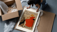 Girl in red dress drinking from bowl framed print being unpacked from protective bubble wrap and a box