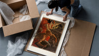Woman leading revolutionaries with red flag framed print being unpacked from protective bubble wrap and a box