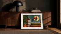 Child watching witch fly past window print in a black frame leaning against a walnut console in lamplight