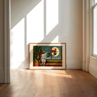 Child watching witch fly past window print in an oak frame on a sunlit wood floor beneath tall window light