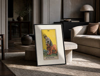 Woman taming a lion print in a black frame leaning on a travertine table in a sunlit lounge