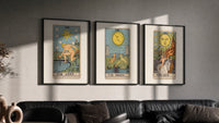 Three 1909 tarot cards triptych in three black frames on a grey wall above a leather sofa