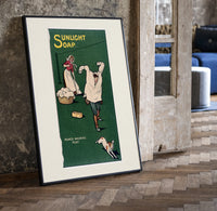 Boy playing with laundry, woman washing print in a black frame leaning beside a vintage door on parquet