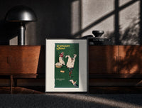 Black-framed Boy playing with laundry, woman washing print on a moody console with designer coffee-table books
