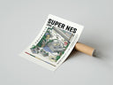 Rolled Super Nintendo game console with controller poster beside its crush-resistant kraft shipping tube