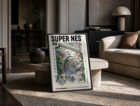 Super Nintendo game console with controller print in a black frame leaning on a travertine table in a sunlit lounge