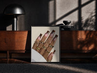 Black-framed Swirl Manicure with a Heart Ring print on the floor in front of a dark wooden console
