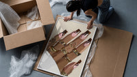 Swirl Manicure with a Heart Ring framed print being unpacked from protective bubble wrap and a box