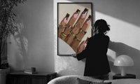Swirl Manicure with a Heart Ring print in a slim black frame being hung on a sunlit wall in a monochrome room