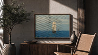 Tall sailing ship at sea print in a wood frame above a fluted sideboard beside an olive tree