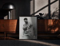 Black-framed Basketball player celebrating with ball print on a moody console with designer coffee-table books