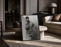 Basketball player celebrating with ball print in a black frame leaning on a travertine table in a sunlit lounge