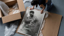 Basketball player celebrating with ball framed print being unpacked from protective bubble wrap and a box