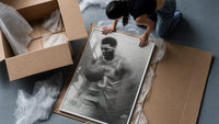 Basketball player celebrating with ball framed print being unpacked from protective bubble wrap and a box