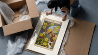 Ten of Pentacles tarot card framed print being unpacked from protective bubble wrap and a box