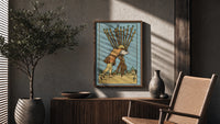 Ten of Wands poster framed above a fluted sideboard beside a potted tree