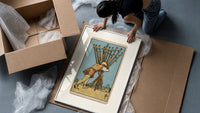 Man carrying ten wooden staves framed print being unpacked from protective bubble wrap and a box