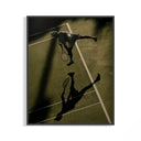 Aerial tennis poster of a player at the top of a serve with a long court shadow displayed on a wall