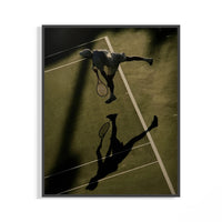 Aerial tennis poster of a player at the top of a serve with a long court shadow displayed on a wall