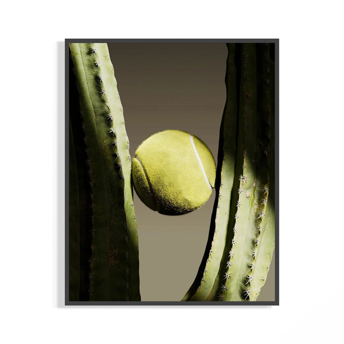 Yellow tennis ball nestled between green cactus arms in a framed minimal sports poster on display